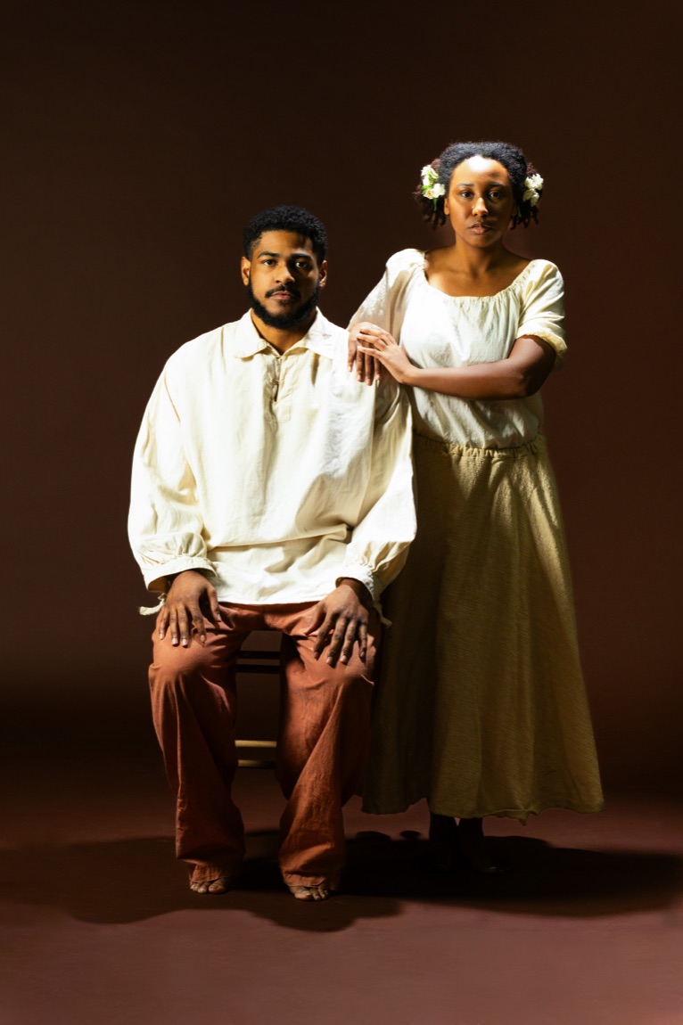 A couple in 1860s period dress in a formal portrait